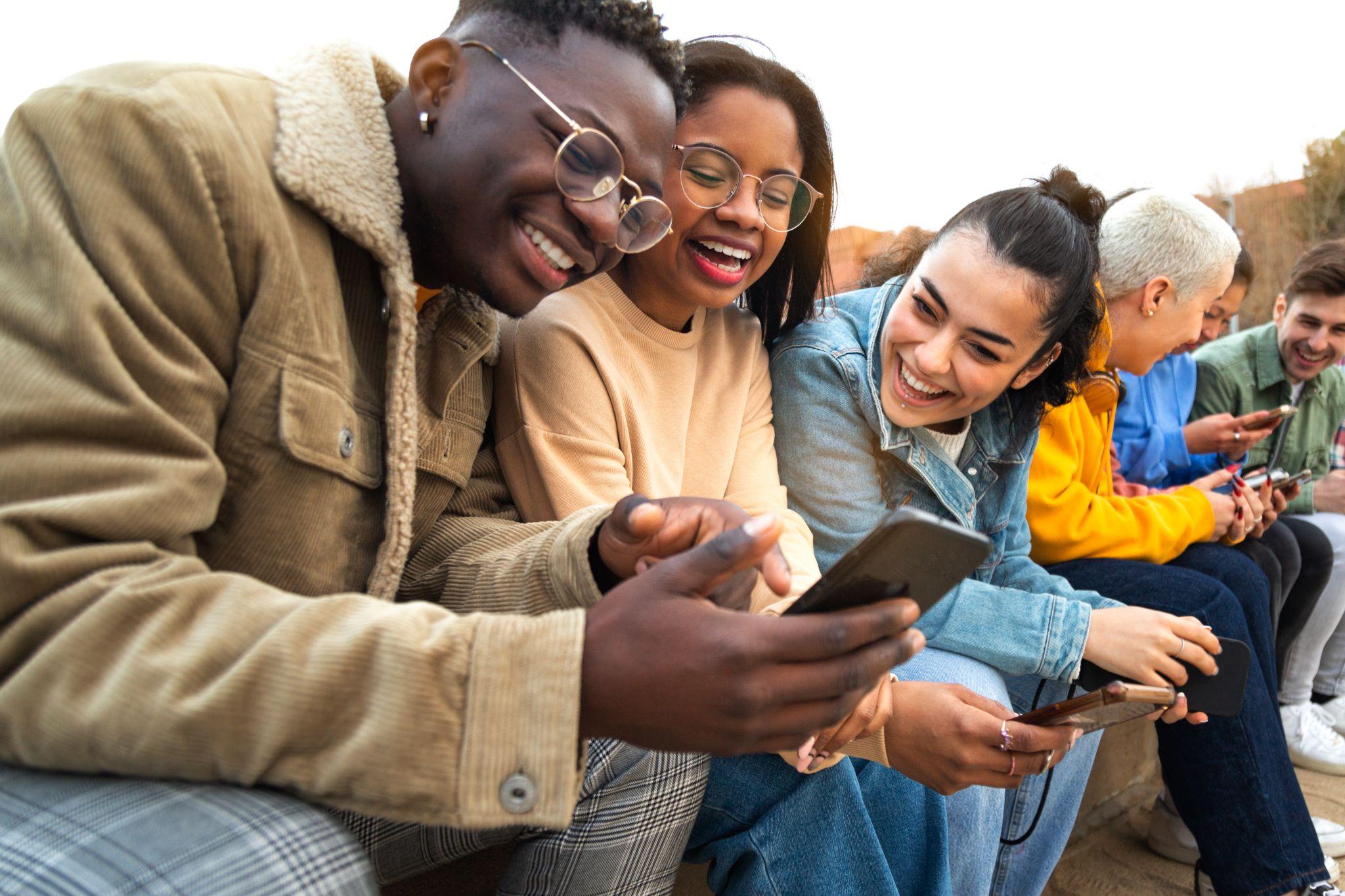 Happy multiracial teen college students on snapchat