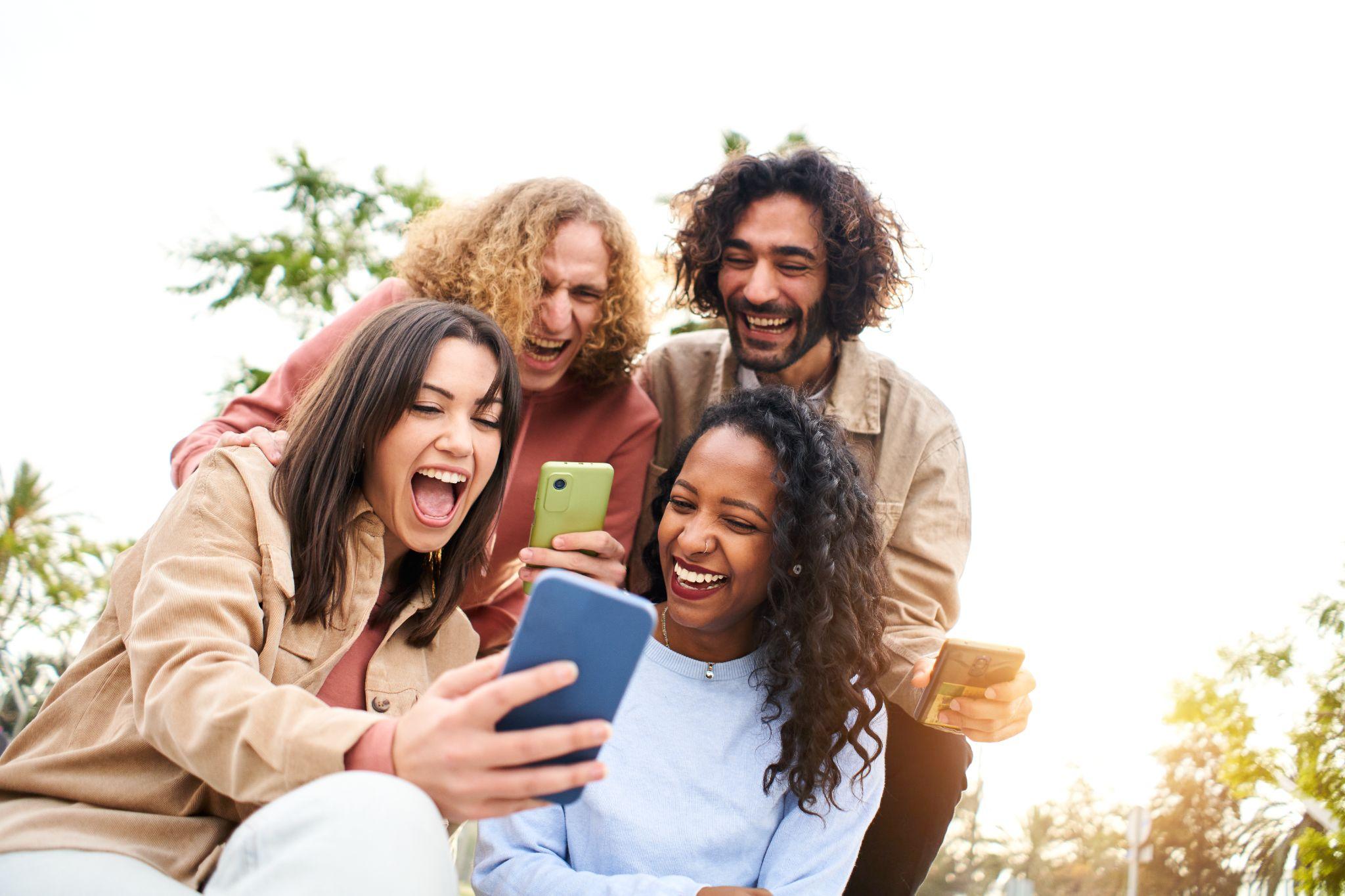 Happy friends watching screen mobile phone