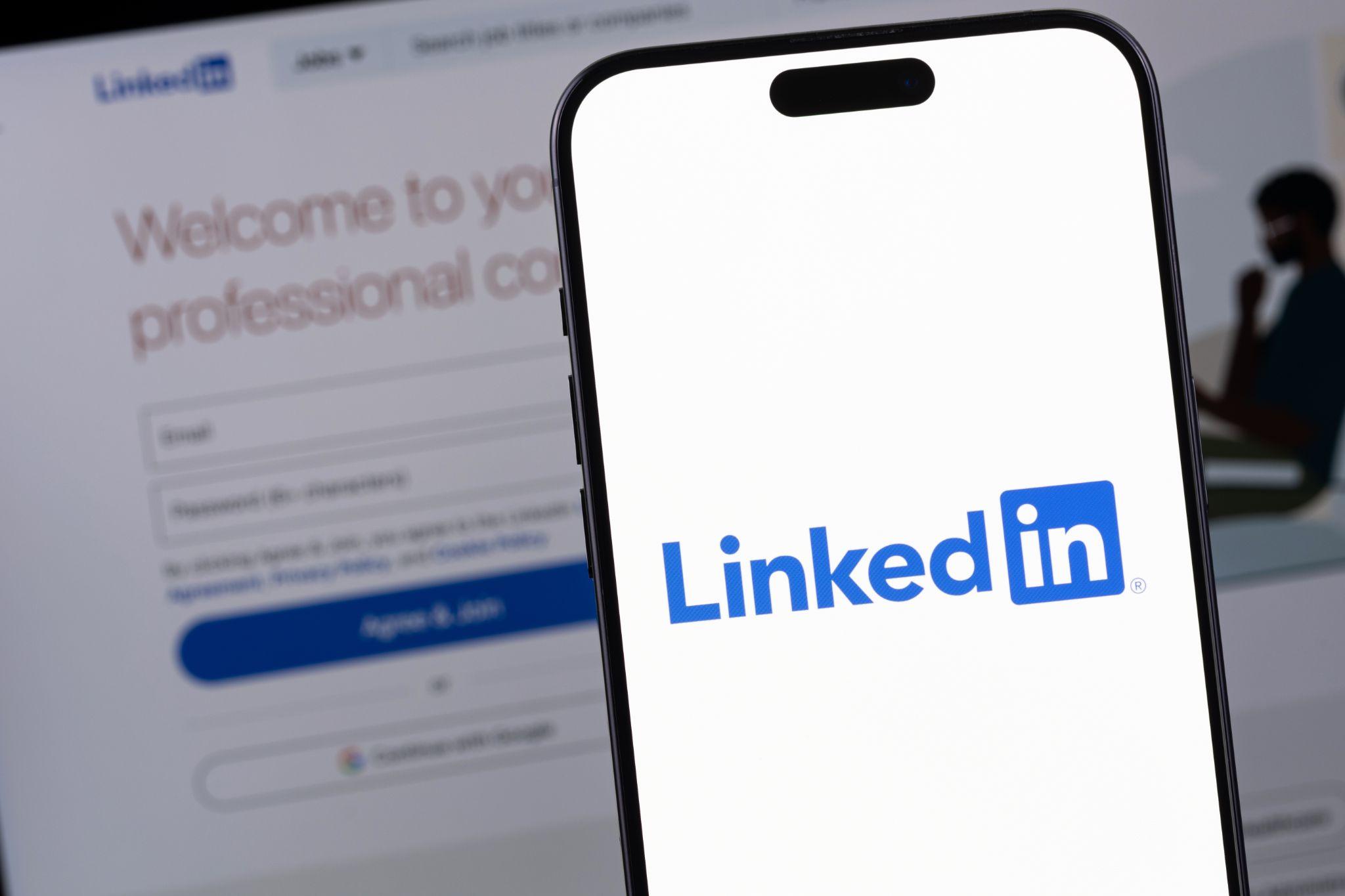 Linkedin app open on iphone and laptop