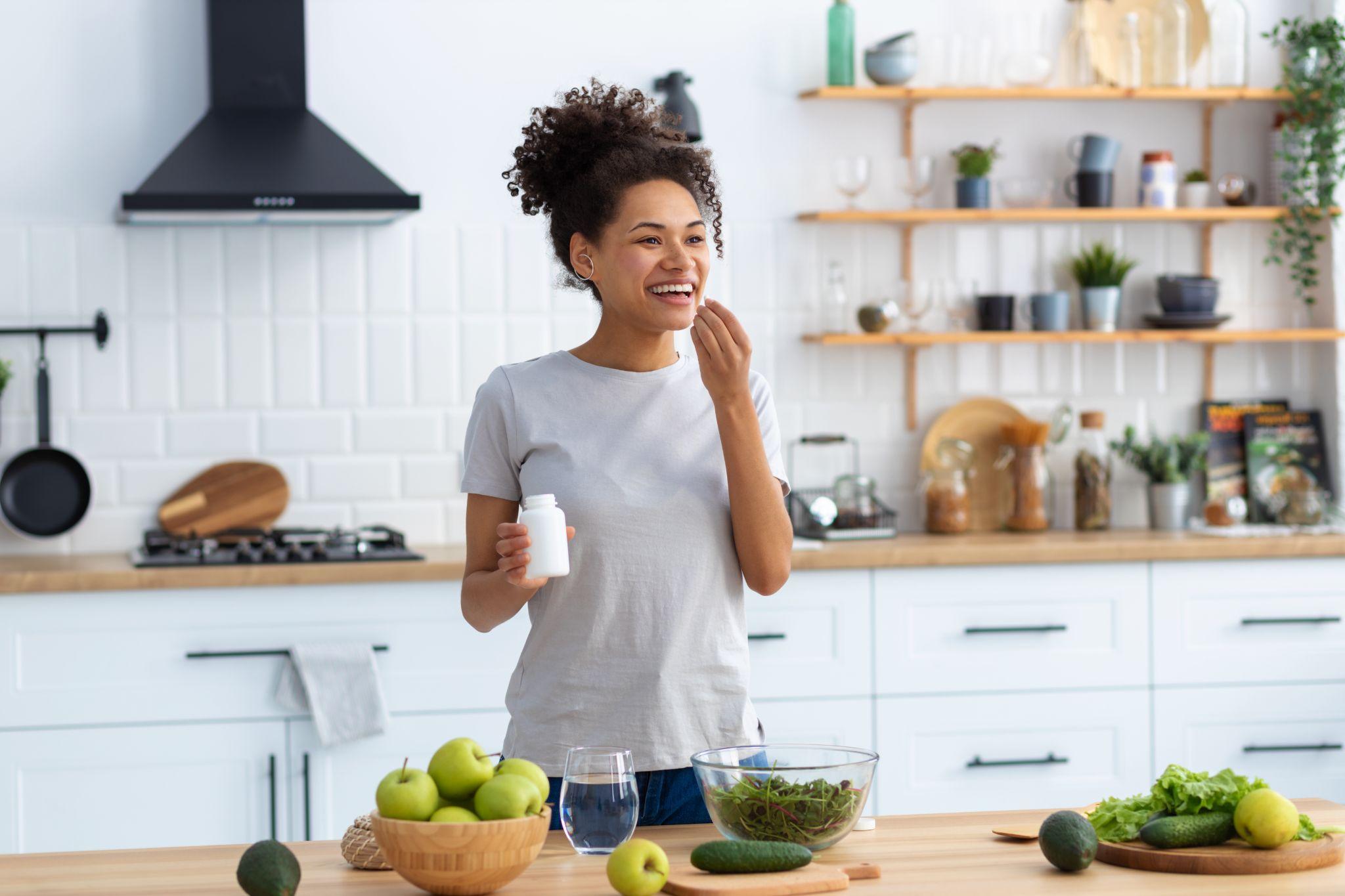 Happy woman taking supplements