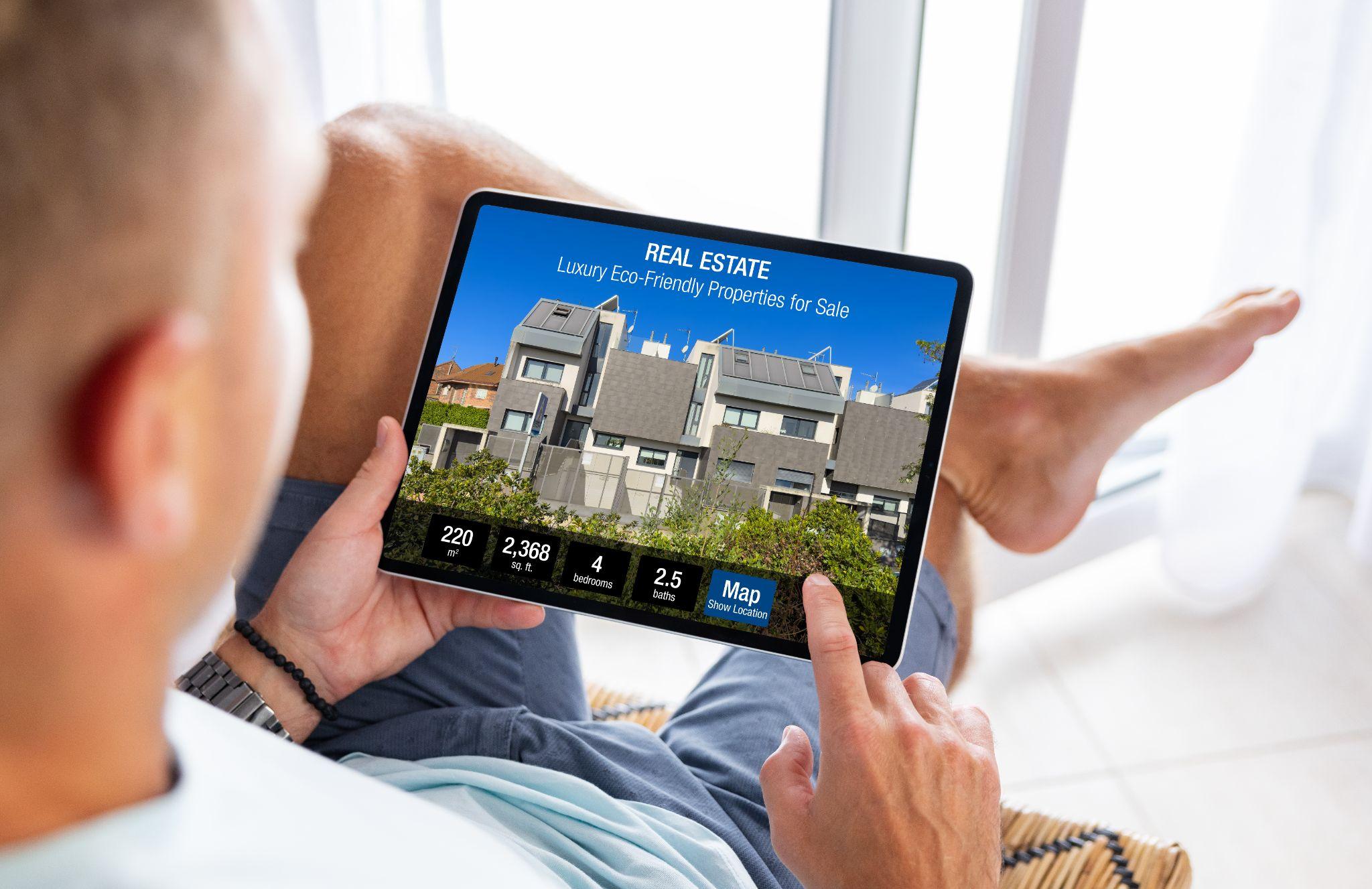 Man looking at a real estate website on tablet computer