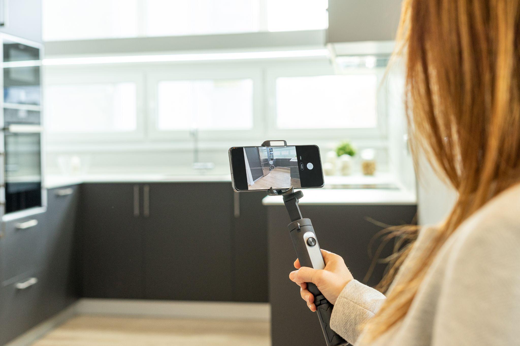 Real estate agent filming an open house