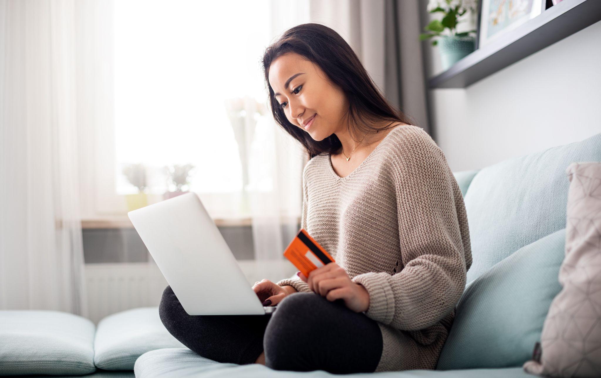 Happy female customer buying something on a computer